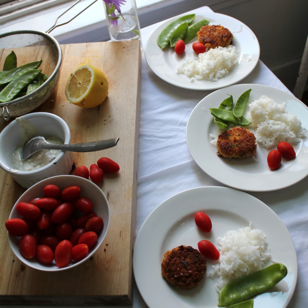 shrimp cakes with a tartar sauce aoli served with jasmine rice, grape tomatoes and snow peas