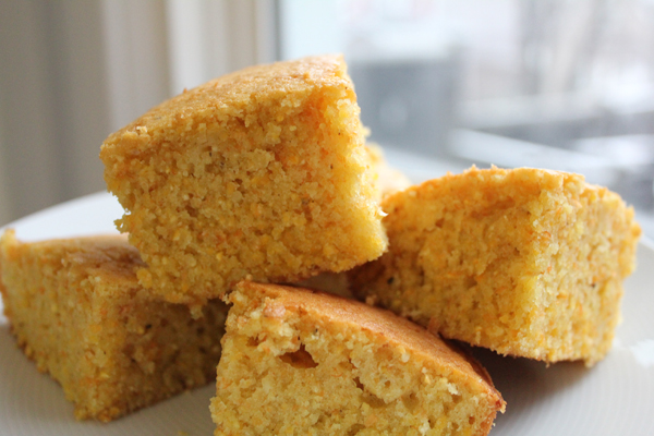 Slices of cornbread stacked on a plate